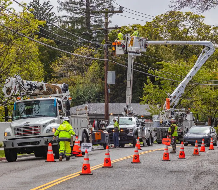 Bucket truck parked near residential home for tree trimming